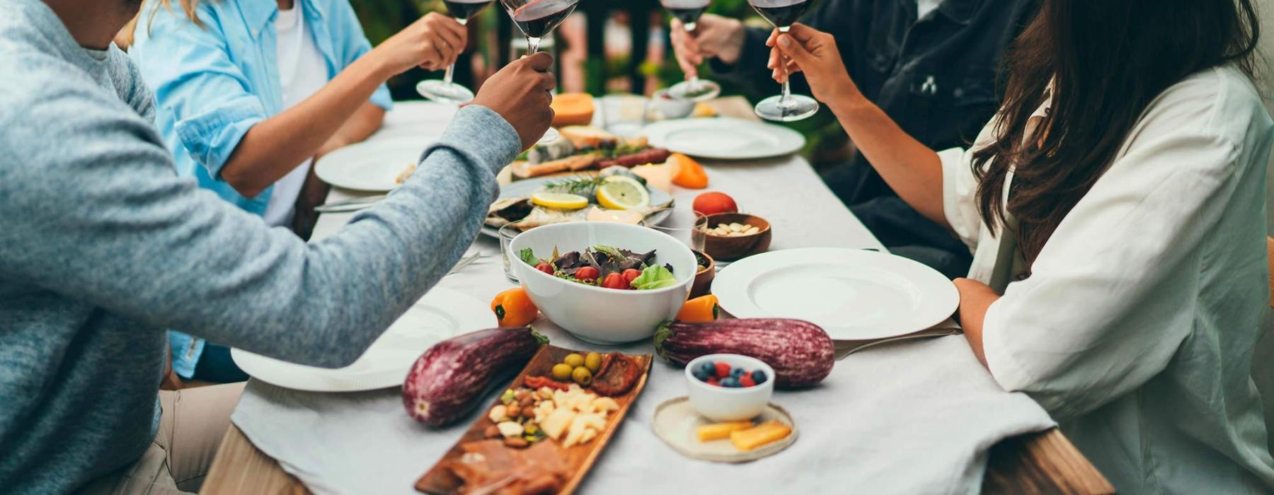 a group of people having a meal around an outdoor table