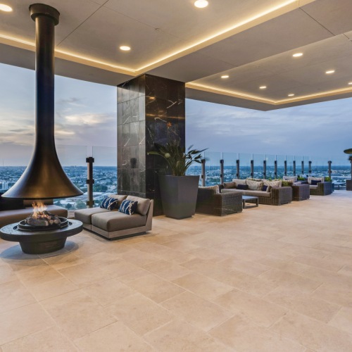 rooftop open air covered lounge with floating fireplace and lounge seating