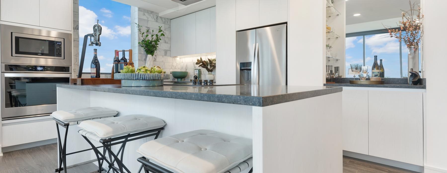 a kitchen with a bar stools